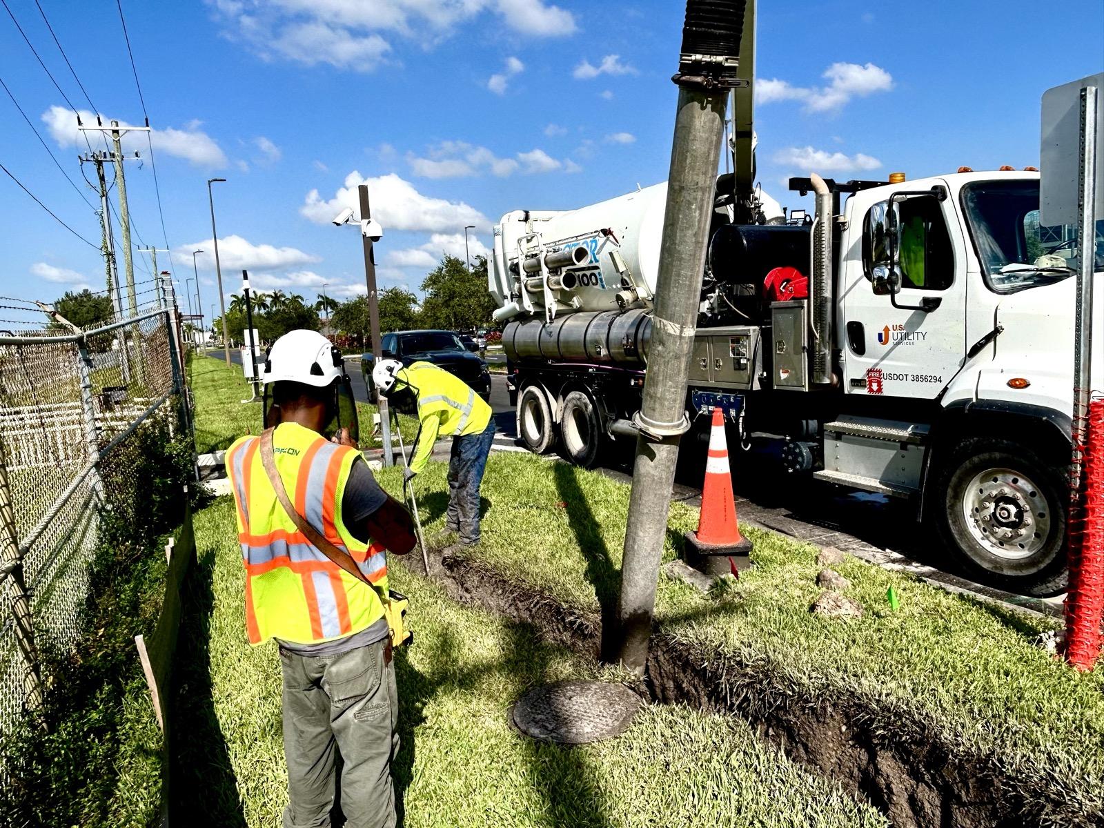 US Utility Services crew potholing to expose live underground utilities with a vacuum excavation truck in South Florida